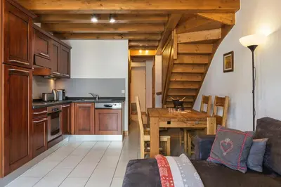a living room with a couch and a large window at Chateau - Charming Apartment in the city Center with 3 bedrooms - By Cozee Rentals in Saint-Gervais-les-Bains