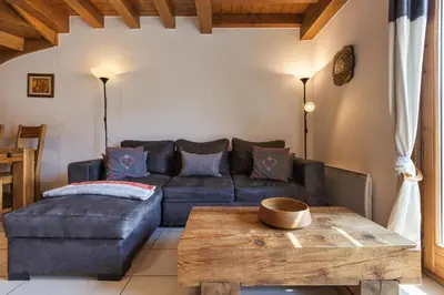 a kitchen with a couch and a table in a room at Chateau - Charming Apartment in the city Center with 3 bedrooms - By Cozee Rentals in Saint-Gervais-les-Bains