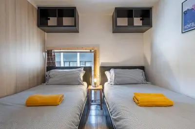 two beds sitting next to each other in a room at Grand Roc A - 3 bedrooms Apartment Next to skilift - By Cozee Rentals in Chamonix-Mont-Blanc