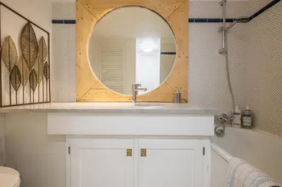 a bathroom with a sink and a mirror at Grand Roc A - 3 bedrooms Apartment Next to skilift - By Cozee Rentals in Chamonix-Mont-Blanc
