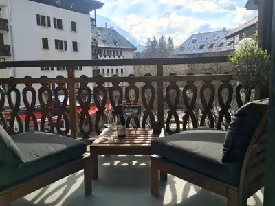 a balcony with two chairs and a table on a balcony at Chamonix Sud studio with Mont Blanc views in Chamonix-Mont-Blanc