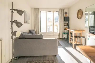 a living room with a couch and a table at Chamonix Sud studio with Mont Blanc views in Chamonix-Mont-Blanc