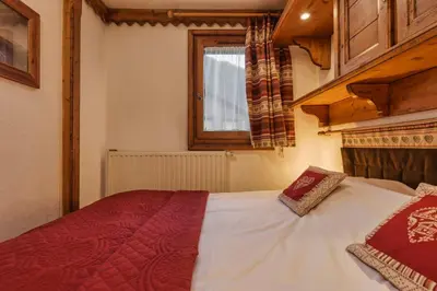 a bedroom with a white bed with a window at Grepon -City Center - Free Swimming pool, Sauna, Gym - Free Parking - By Cozee Rentals in Chamonix-Mont-Blanc