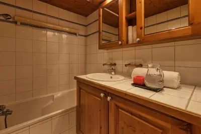 a bathroom with a sink and a bath tub at Grepon -City Center - Free Swimming pool, Sauna, Gym - Free Parking - By Cozee Rentals in Chamonix-Mont-Blanc