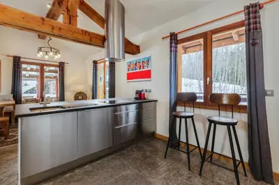 a kitchen with a large stainless steel counter top at Chalet Fleur de Lys - Chalet 4BR Wood Stove , Home Cinema , Parental Suite - By Cozee Rentals in Les Houches