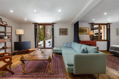 a living room with a couch and a table at Chalet Fleur de Lys - Chalet 4BR Wood Stove , Home Cinema , Parental Suite - By Cozee Rentals in Les Houches