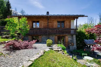 a living room with a couch and a tv at Chalet Fleur de Lys - Chalet 4BR Wood Stove , Home Cinema , Parental Suite - By Cozee Rentals in Les Houches