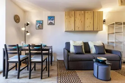 a living room with a couch and a table at Epicea - Chic 2BR in city center, next to Train Station - By Cozee Rentals in Chamonix-Mont-Blanc