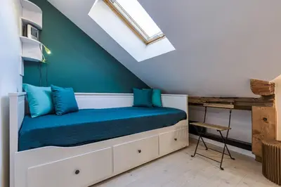 a bedroom with a bed and a skylight at Epicea - Chic 2BR in city center, next to Train Station - By Cozee Rentals in Chamonix-Mont-Blanc