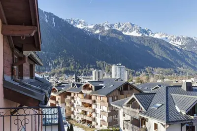 a view of a city with mountains in the background at Epicea - Chic 2BR in city center, next to Train Station - By Cozee Rentals in Chamonix-Mont-Blanc