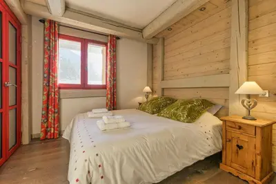 a bedroom with a bed with towels on it at La Blaitière - Luxe Apart Center Chamonix , Next to Piste Planard - By Cozee Rentals in Chamonix-Mont-Blanc