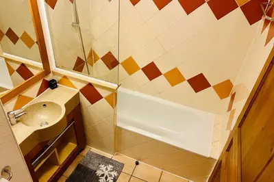 a small bathroom with a shower and a sink at Nice Apt With Balcon In The Downtown ! in Chamonix-Mont-Blanc