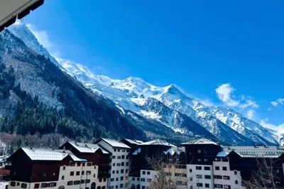 a balcony with a table and a view of a mountain at Nice Apt With Balcon In The Downtown ! in Chamonix-Mont-Blanc