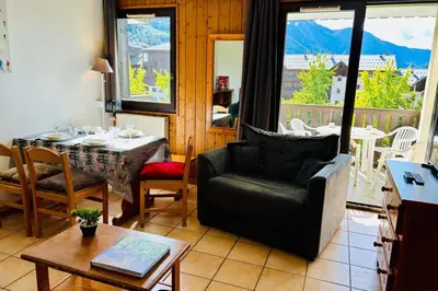 a bedroom with a bed and a desk and a picture at Nice Apt With Balcon In The Downtown ! in Chamonix-Mont-Blanc
