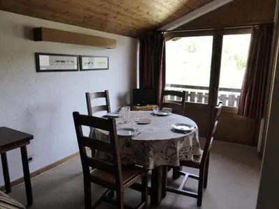 a dining room with a table and chairs and a window at Résidence Princesse En Etraz Narcisse - Princesse en Etraz N41 MAE-2294 in Combloux