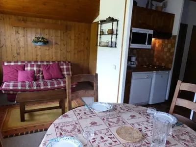 a dining room with a table and a kitchen at Résidence Princesse En Etraz Narcisse - Princesse en Etraz N41 MAE-2294 in Combloux