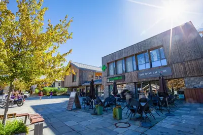 a building with tables and chairs in front of it at Appartement Central Des Houches - 15 - Happy Rentals in Les Houches