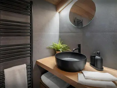 a bathroom with a black sink and a mirror at Chalet Fanfoua - OVO Network in Combloux