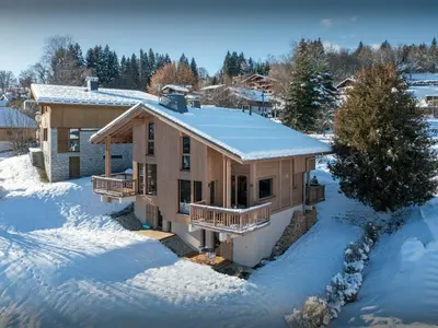 a house covered in snow in the snow at Chalet Fanfoua - OVO Network in Combloux