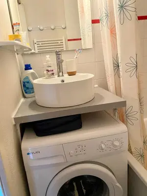 a washing machine with a sink on top of it at Duplex Samoëns 4/6 couchages in Samoëns