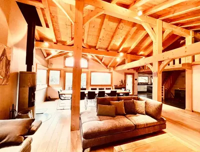 a large living room with a couch and a table at Chalet Isabelle Mountain lodge 5 star 5 bedroom en suite sauna jacuzzi in Chamonix-Mont-Blanc