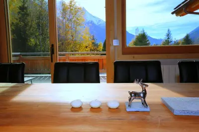 a toy deer sitting on top of a wooden table at Chalet Isabelle Mountain lodge 5 star 5 bedroom en suite sauna jacuzzi in Chamonix-Mont-Blanc