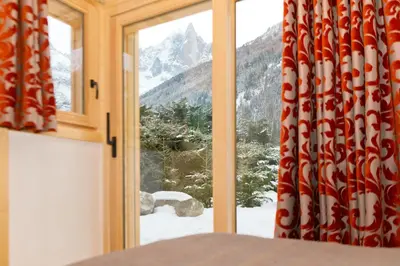 a window with a view of a snow covered mountain at Chalet Isabelle Mountain lodge 5 star 5 bedroom en suite sauna jacuzzi in Chamonix-Mont-Blanc