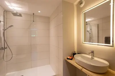 a bathroom with a sink and a shower at Chalet du Gouter - Chamonix All Year in Chamonix-Mont-Blanc