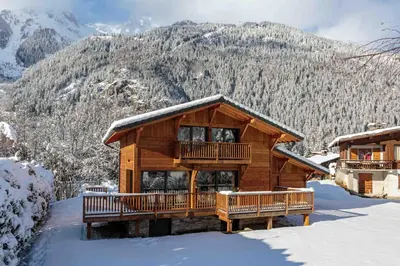 a log cabin with a balcony in the snow at Chalet du Gouter - Chamonix All Year in Chamonix-Mont-Blanc