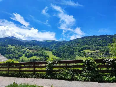 a wooden fence with a view of a valley at Studio & piscine intérieure, vue Mont D'Arbois in Saint-Gervais-les-Bains