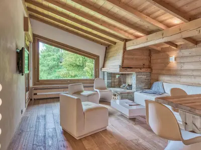 a bedroom with a bed and chairs and a fireplace at Appartement 3P 6 pers. proche pistes, wifi, garage - FR-1-453-293 in Megève