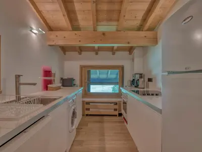 a kitchen with white counters and a wooden ceiling at Appartement 3P 6 pers. proche pistes, wifi, garage - FR-1-453-293 in Megève