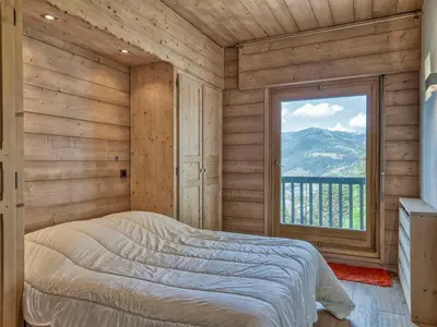 a bedroom with a bed and a large window at Appartement 3P 6 pers. proche pistes, wifi, garage - FR-1-453-293 in Megève