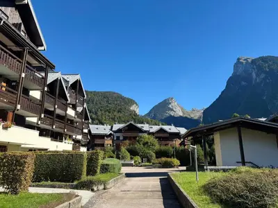 a street in a resort with mountains in the background at Studio rénové au centre avec balcon et parking - FR-1-624-106 in Samoëns