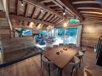 a dining room with a wooden table and chairs at Chalet Lily by Brennus Chamonix in Chamonix-Mont-Blanc