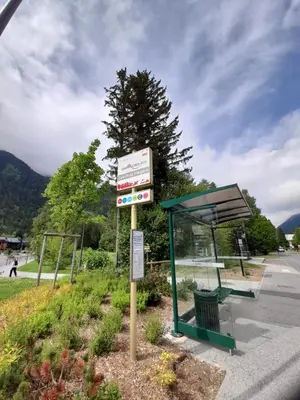 a bus stop with a sign next to a bus at Chalet Lily by Brennus Chamonix in Chamonix-Mont-Blanc