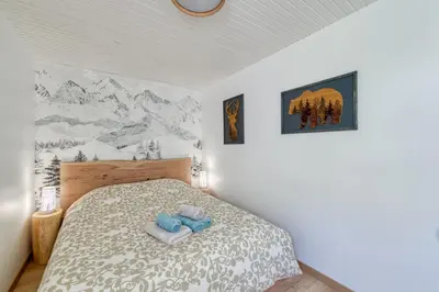 a bedroom with a bed with towels on it at Le Petit Balcon avec vue sur le Mont-Blanc in Chamonix-Mont-Blanc