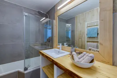 a bathroom with a sink and a mirror at Le Petit Balcon avec vue sur le Mont-Blanc in Chamonix-Mont-Blanc