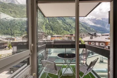 a view from the window of a room with a table and chairs at Le Petit Balcon avec vue sur le Mont-Blanc in Chamonix-Mont-Blanc