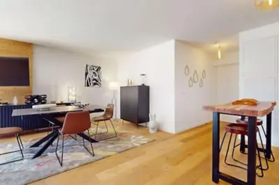 a living room with a table and chairs at Les Carlines 09 in Samoëns