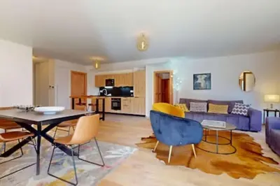 a living room with a table and chairs at Les Carlines 09 in Samoëns