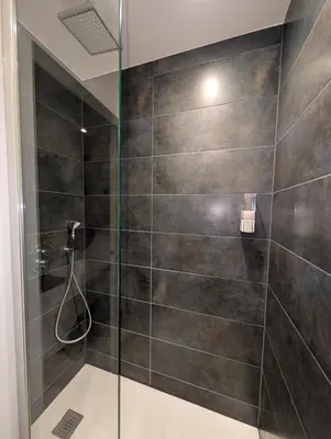 a bathroom with a shower with a glass door at LE YAMA in Chamonix-Mont-Blanc