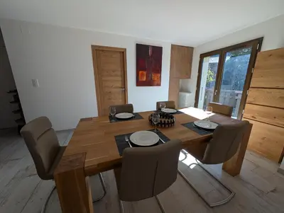 a dining room with a wooden table and chairs at LE YAMA in Chamonix-Mont-Blanc