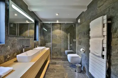 a bathroom with two sinks and a shower at Chalet Black Stone in Chamonix-Mont-Blanc