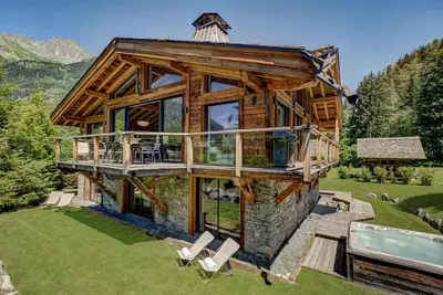 a large log house with a pool and a deck at Chalet Black Stone in Chamonix-Mont-Blanc