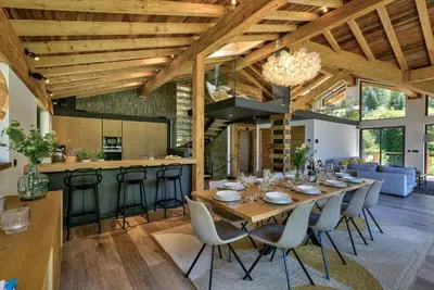 a dining room and kitchen with a long table and chairs at Chalet Black Stone in Chamonix-Mont-Blanc