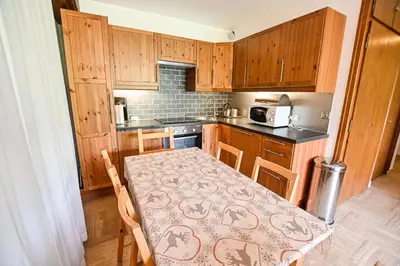 a small kitchen with a table with a pattern on it at Panoramic Megève in Megève