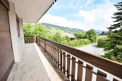a balcony with a view of the mountains at Panoramic Megève in Megève