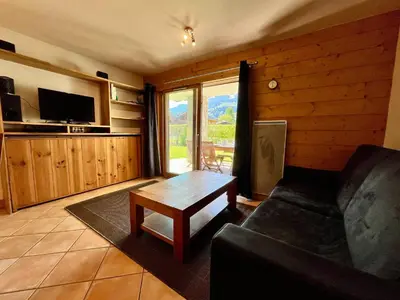 a living room with a couch and a coffee table at Appartement T2 avec grande terrasse et animaux acceptés - FR-1-624-105 in Samoëns