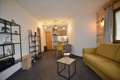 a living room with a couch and a table at DOMAINE DU GRAND TETRAS SAMOENS in Samoëns